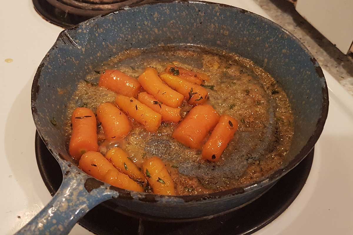 Glazed thyme carrots in frying pan