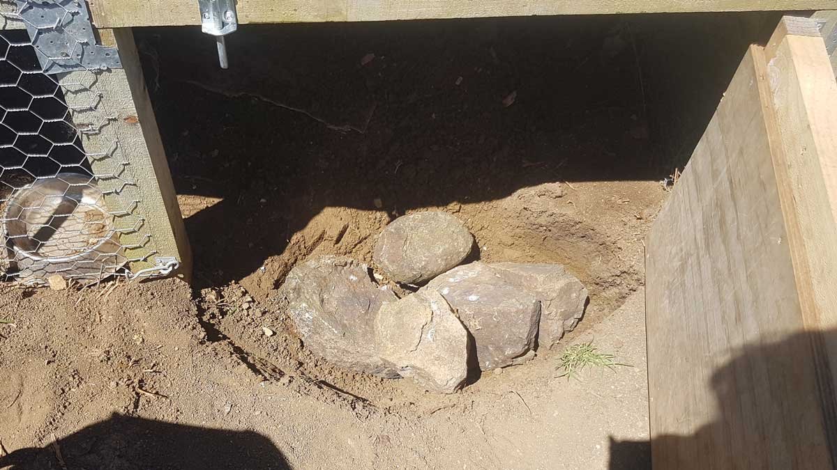 Large rocks added to the hole to take up the bulk of the space