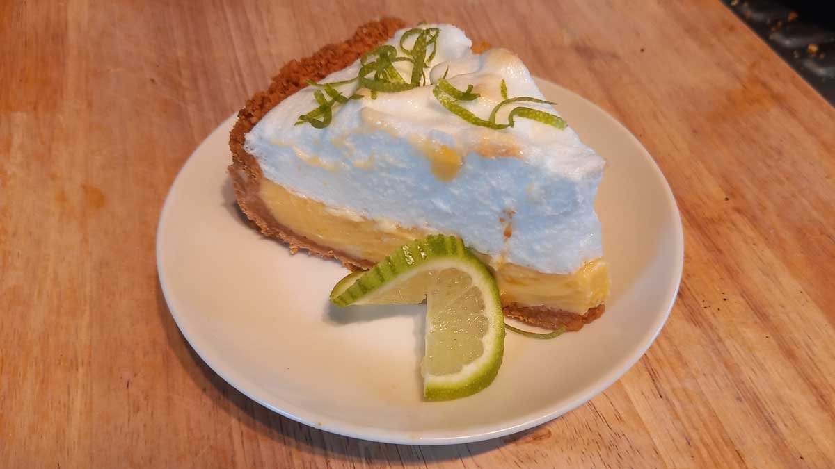 Slice of key lime meringue pie