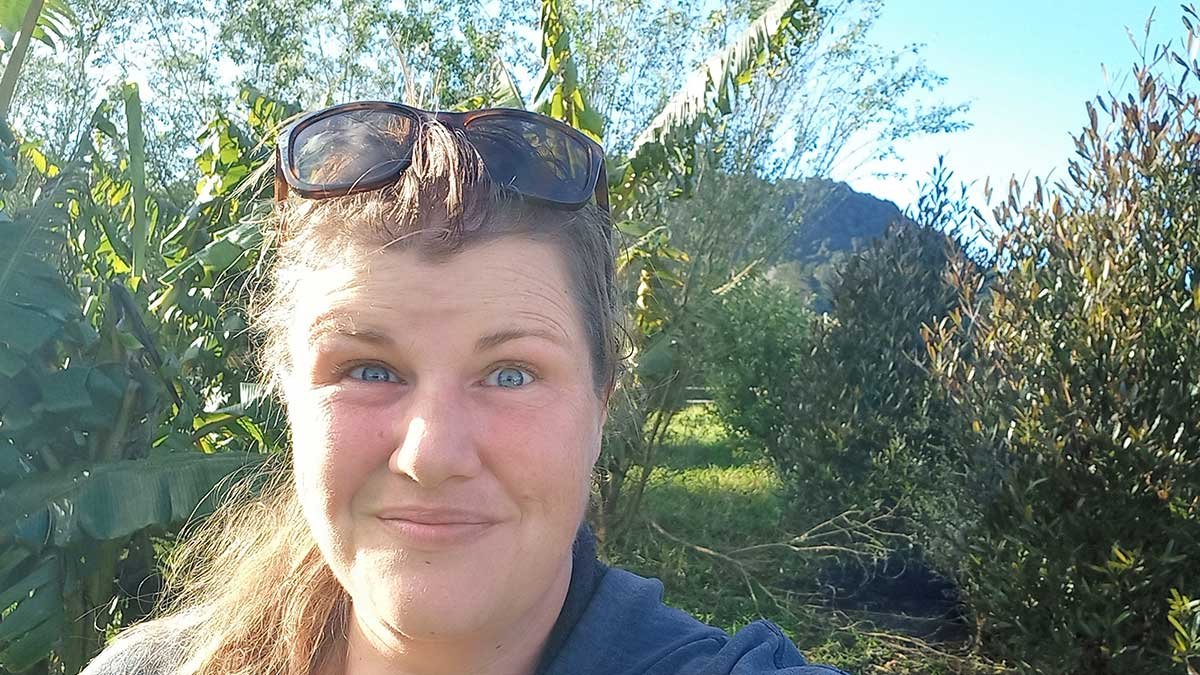 Kat in front of the banana planting, August 2022