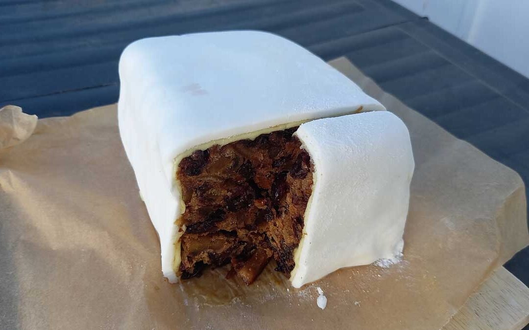 Nana Retter's fruit cake - fully iced with a piece cut out.