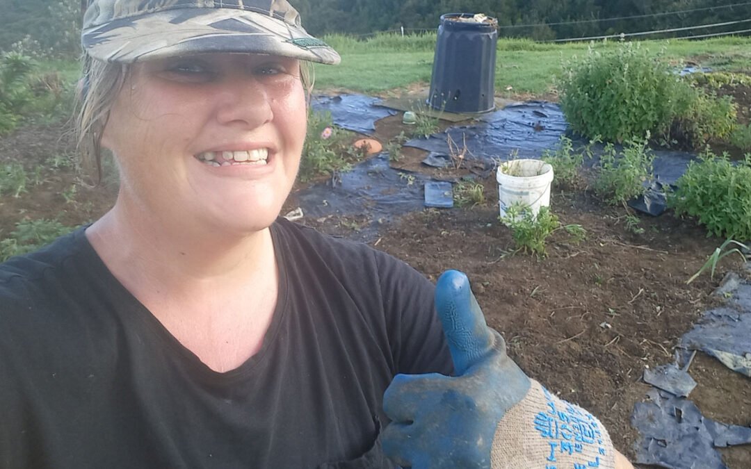 Selfie of Kat doing the thumbs up at the camera after weeding the garden bed.