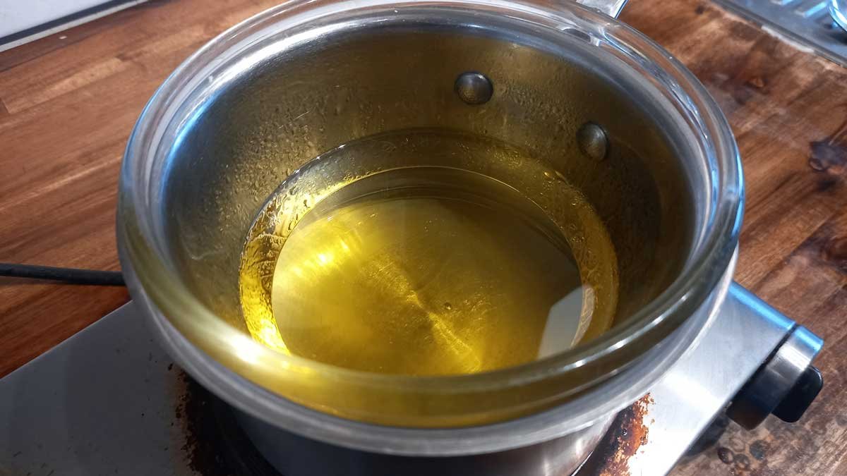 Olive oil warming in a double boiler.