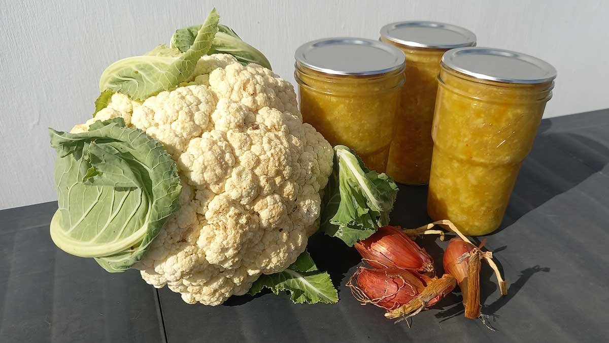 Cauliflower and pineapple pickle with a head of cauliflower and some shallots.