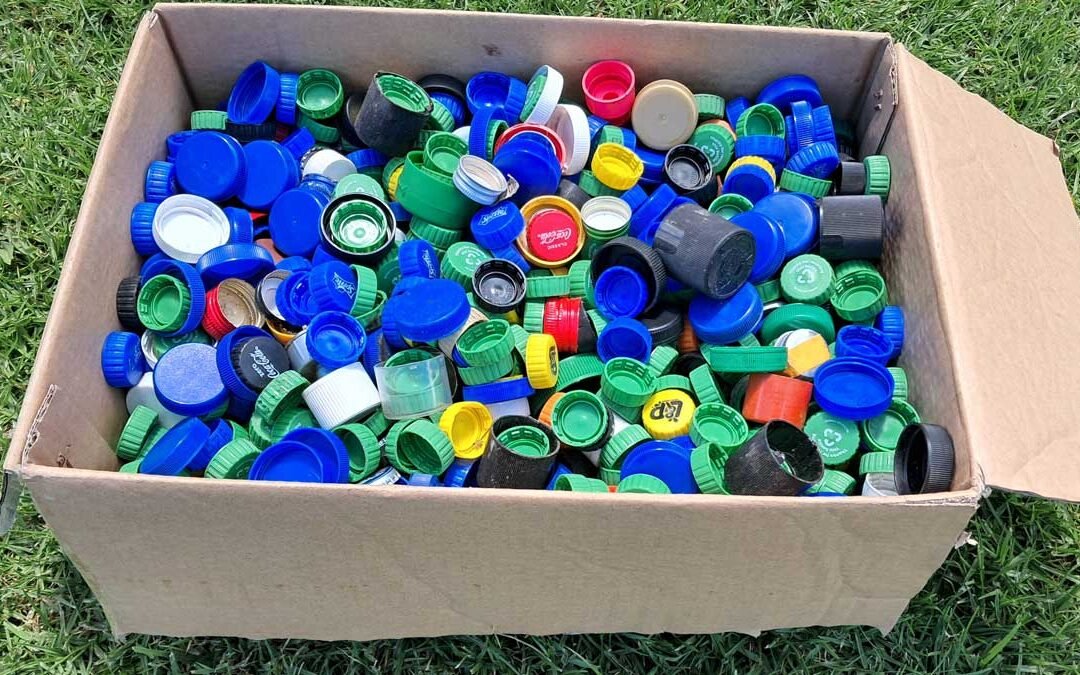 A box full of plastic bottle lids.