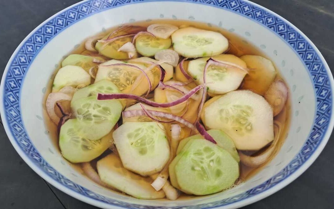 A bowl of cucumber and red onion quick pickle