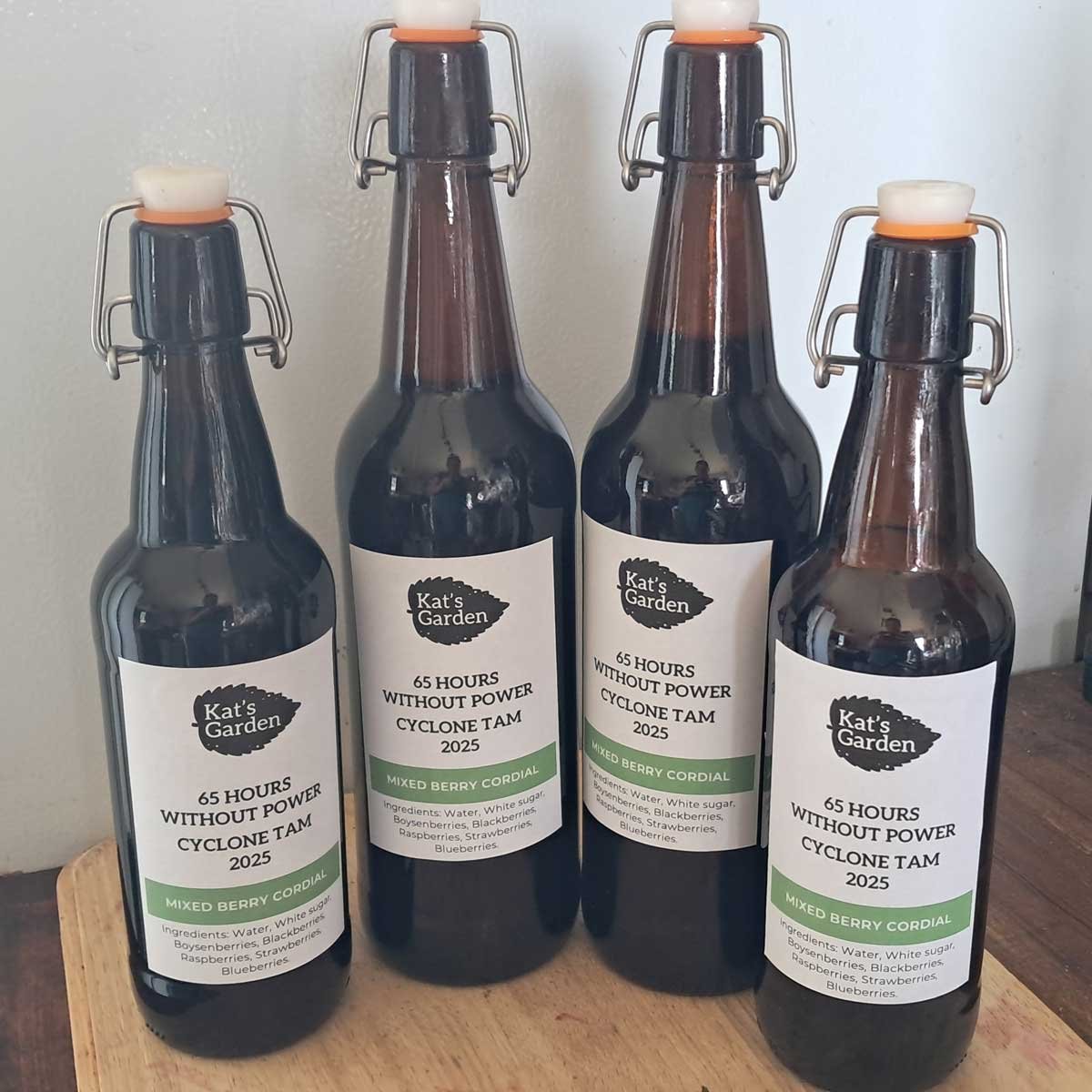 Four labelled brown bottles containing berry cordial. Four labelled brown bottles containing berry cordial.
