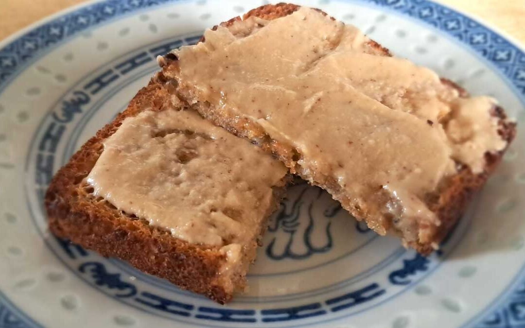 A slice of wholegrain toast smothered in peanut butter.