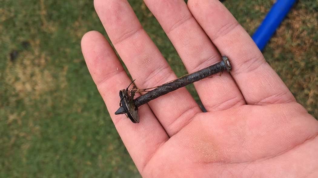 A roofing nail held in my fingers.