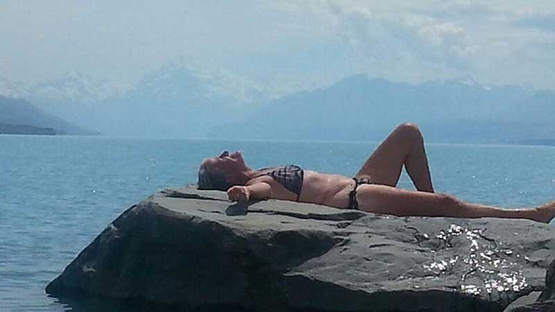 Marilyn Jenkins sunbathing in a bikini at Lake Pukaki around 2015.