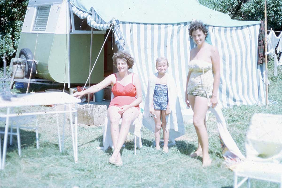 Shirley Fulton, Marilyn Fulton, and Pat Fulton (nee Joines) in front of their caravan at Māhia, mid-1960's.