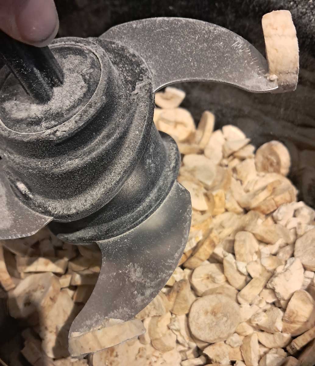 Dried banana chips stuck to the ends of a food processor blade.