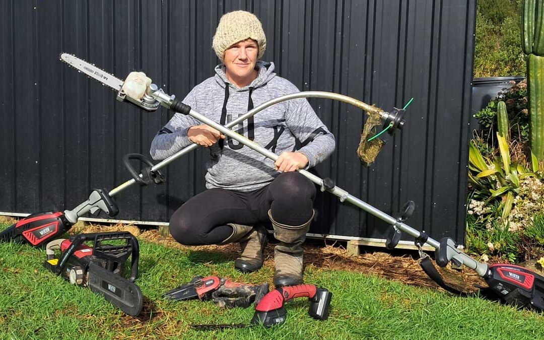 Kat posing with her collection of powertools like this is Tinder and they are fish.